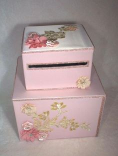 two pink boxes with flowers painted on them