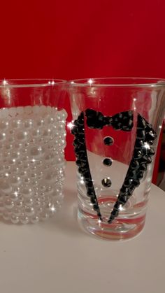 two glasses with beads and a bow tie on them