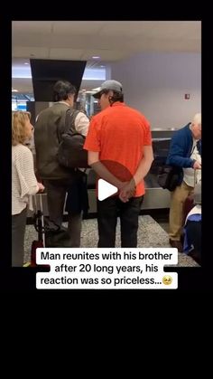 a group of people standing around each other in an airport