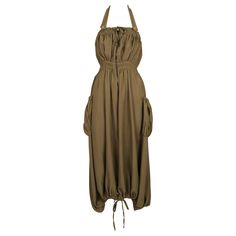 Very rare, khaki parachute dress with ruched pockets and adjustable drawstrings designed by Jean Paul Gaultier dating to the late 1990's. Labeled a French size 38. Measurements are very difficult to take because of elastic and adjustable nature of bust and hem. Approximate waist measurement (unstretched) 24". Best fits a French 38. Photographed on a size 36 and the dress was not clipped. Zips up center front. Adjustable strap at neck. Pockets at bust and hips. Made in Italy. Good condition. Jean Paul Gaultier Classique, Parachute Dress, Pink Corset, Bias Cut Dress, Runway Dresses, Tulle Fabric, Formal Style, Paul Gaultier, Dress For Sale