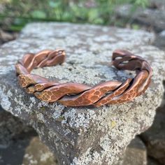 A larger and heavier version of our most popular bracelet. Artsy yet rugged, this unique, hand forged, pure copper bracelet was made for those who appreciate the raw and natural properties of copper. Different gauge wire was combined and formed before forging and peening. Burrs are carefully removed and sharp edges filed by hand before final sanding to maintain an antiqued patina. Copper is annealed to provide the user a bracelet that is strong yet soft enough to bend to a comfortable fit. Finis Unique Hammered Copper Bracelets, Hand Forged Copper Bangle Bracelet, Handmade Copper Bangle Bracelets, Hand Forged Bronze Copper Cuff Bracelet, Artisan Bronze Copper Cuff Bracelet, Bronze Electroformed Metal Bracelet, Bronze Copper Bracelet With Patina, Handmade Rustic Copper Cuff Bracelet, Handmade Rustic Bronze Bracelets