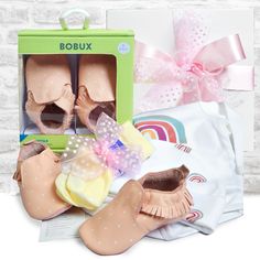 The perfect layette gift box for a newborn baby girl! This Organic Cotton Baby Girl Layette gift box includes a 100% organic cotton Rainbow Bodysuit, an organic cotton Rainbow Hat, a pair of NZ Bobux soft sole leather pink baby shoes and NZ made Merino Wool Baby Socks. The organic cotton baby clothing is ideal for a delicate new baby girl and meets the Global Organic Textile Standard. Bobux leather baby shoes are designed in New Zealand and come recommended by podiatrists and paediatricians. Rainbow Bodysuit, Baby Pink Shoes, Rainbow Hat