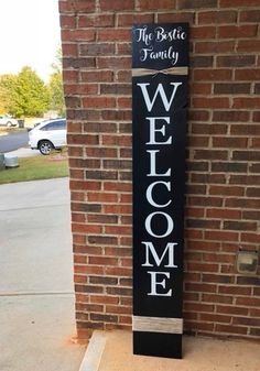 a welcome sign on the side of a brick building