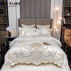 a bed with white comforter and pillows in a room