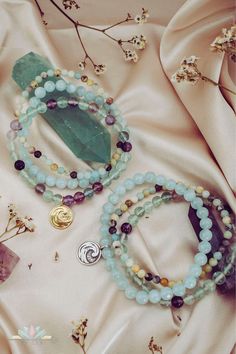 Wear this powerful Water element bracelets stack when you feel the need to connect with celestial energies of the universe and draw in peace, strength and calmness. This gemstone stretch bracelet trio of Aquamarine, Amazonite and Fluorite offers transmutive energy and harmonizes effortlessly, helping you adjust and adapt to natural flows of life. Water element charm, symbolizing balance, communication and aura cleansing, adds a soulful touch to this gorgeous bracelet stack. Water Element: Cool, Spiritual 8mm Beads Wrap Bracelet For Healing, Spiritual Healing Wrap Bracelet With 8mm Beads, Spiritual Healing Wrap Bracelet With Round Beads, Mystical Healing Gemstone Beads Bracelets, Spiritual Amazonite Crystal Bracelet For Healing, Stackable Beaded Bracelets For Meditation, Spiritual Amazonite Gemstone Beads Bracelet, Spiritual Healing Gemstone Beads Wrap Bracelet, Spiritual Amazonite Bracelets With Gemstone Beads