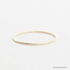 A substantial half-round bangle with a flat Interior, ideal for celebrating a decade of marriage or special occasion.A 2.25mm solid 14k gold half round bangle with a flat interior. Hammered Bangles, Flat Interior, Gold Flats, Stacked Bangles, White Solid, Gold Bangle, Hand Engraving, Yellow Rose, Gold Bangles