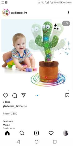 a baby is playing with a toy cactus