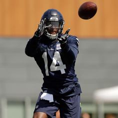 a football player throwing a ball in the air