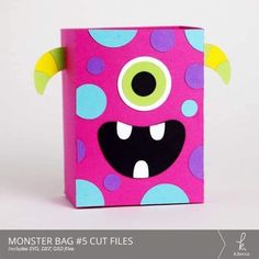 a pink box with monster eyes and polka dots on the inside, sitting in front of a white background