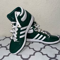 Elevate Your Sneaker Game With These Adidas Top Ten Rb Sneakers In Green, And White. The Athletic Shoe Features A High-Top Shoe Shaft Style With Lace-Up Closure For A Secure Fit. The Upper Material Is Made Of Leather With A Patent Finish, While The Outsole Material Is Rubber Providing Comfort And Durability. These Sneakers Are Perfect For Casual Wear Or Activewear, And Can Be Worn In Any Season - Winter, Summer, Fall, Or Spring. The Adidas Top Ten Rb Sneakers Also Feature Trefoil Branding, Solid Custom Green Adidas Sneakers, Green High-top Basketball Shoes With Laces, Adidas Custom Green Sneakers With Laces, Adidas Custom Green Sporty Sneakers, Adidas Sporty Green Custom Sneakers, Sporty Green Adidas Custom Sneakers, Green Leather High-top Sneakers For Sports, Green Adidas Sneakers With Laces, Green Synthetic High-top Sneakers With Boost Midsole