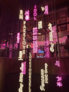 neon lights hanging from the ceiling in front of a building