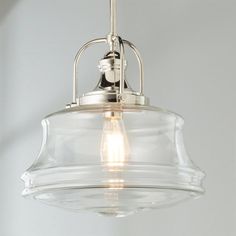 a clear glass light fixture hanging from a ceiling