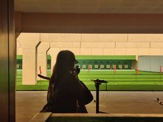 a woman with long hair is talking on her cell phone while standing in an empty building