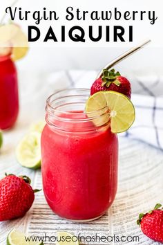 a mason jar filled with raspberry daiquit and topped with a lime wedge