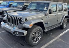 several jeeps are parked in a parking lot