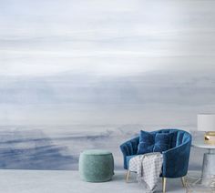 a blue chair sitting next to a white table