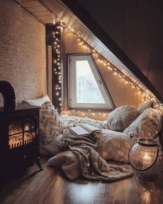 an attic bedroom is decorated with fairy lights