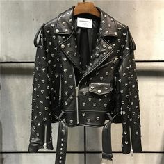 Heavy duty, black, soft genuine leather biker motorcycle style jacket with silver heart stud rivets all over. Features a zip-up collar, front zip pockets, and zippers on sleeve wrists. Poly satin lined with a belted waist for a relaxed, boxy fit. Perfect for adding an edgy touch to any outfit. Pair with jeans and boots for a classic biker look or layer over a dress for a chic, rebellious twist. Sizes by waist in inches. Painting Denim, Biker Chick Style, Leather Jacket Fashion, Womens Biker Jacket, Leather Jacket Style, Black Tweed, Motorcycle Style, Jacket Fashion, Fashion Lady