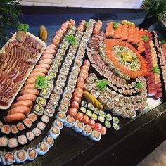 an assortment of sushi on display in a buffet