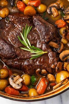 a pot filled with meat and vegetables on top of a table