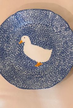 a blue and white plate with a duck painted on it