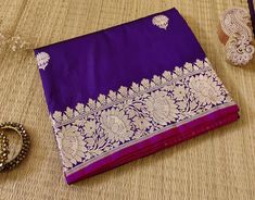 A fabulous and regal saree in Pure Silk. Thus here we bring  to you a Brinjal Banarasi Handloom Katan Silk Saree. Moreover the fabric is pure silk/pattu and the work is in fine golden and silver zari. Thus we would say a not to be missed collection. About Banarasi Weaves A heirloom of Banaras - Katan Silk Saree. These are handloom sarees which takes 2-3 weavers and more than a month to weave a single saree. Furthermore the motifs are inspired my the Mughal era. Additional Information Color : Brinjal Technique: Banarasi Kadhuwa Sona Rupa Weaving Fabric: Pure Katan Silk Blouse Piece: Included Purple Katan Silk Saree With Border, Purple Banarasi Silk Saree With Border, Purple Art Silk Saree With Border, Traditional Wear With Border For Puja And Eid, Purple Saree With Border In Traditional Drape, Purple Traditional Wedding Wear With Border, Purple Katan Silk Lehenga For Puja, Paithani Silk Traditional Wear With Border For Wedding, Bollywood Style Purple Saree With Border