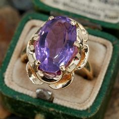 This vintage buttercup style ring features an oval step cut amethyst in a six prong setting. It is crafted in 14k yellow gold and currently a size 7.5. Amethyst Vintage Ring, Extravagant Dresses, Antique Cocktail Ring, Amethyst Rings, Unique Rings Vintage, Vintage Cameo, Step Cut, Prince Charming, Amethyst Ring