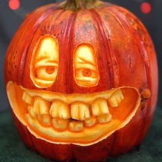 a carved pumpkin with two faces and teeth