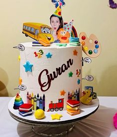 a birthday cake with an image of a child's face on top and toys around it