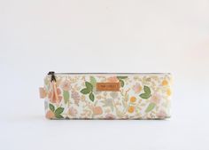 Rifle Paper Co. pencil pouch is 100% handmade! This pouch is perfect for school supplies, office supplies, cosmetics, knitting needles, etc. Both interior and exterior fabrics are high quality. The exterior is paired with a pretty pink interior print, topped off with a metal YKK zipper, and a leather zipper pull. Sandwiched between the layers is a medium-weight interfacing for padding and stability. *Multiples are listed! Pattern placement will vary.  Approximate size: 3.5" Height 9" Wide 2" fla Back To School Gift Zipper Pouch Cosmetic Bag, Daily Use Pencil Case With Zipper, Back To School Gift Cosmetic Bag With Zipper, Rectangular Pouch For Back To School Gift, Green Pencil Case With Pen Holders As Gift, Rectangular Pencil Case With Pen Slots For Crafting, Rectangular Zipper Pouch Pencil Case As Gift, Pencil Shaped Zipper Pouch As Gift, Everyday Pencil Case With Zipper