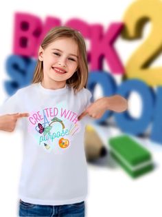 "\"Created With A Porpuse\" It's a nice message for your daughter and the world. A cute shirt for back to school 🆓 FREE SHIPPING 35USD OUR STORE 🆓 🔍 Find more models in my store ✅ HOW TO ORDER (NB! Size runs smaller than usual) 1️⃣ Choose Your Size 2️⃣ Choose Your Shirt Color 3️⃣ Select the quantity 4️⃣ Click Add To Cart. ✅ For multiple items go back to the listing and repeat the steps. 🔴 PLEASE MAKE SURE YOU HAVE READ AND UNDERSTAND THE DESCRIPTION FULLY BEFORE PLACING AN ORDER All Orders M Cotton School T-shirt With Slogan, Fun Short Sleeve T-shirt For School, Fun T-shirt With Text Print For Back To School, Fun T-shirt For End Of School Year, Back To School T-shirt With Text Print, Back To School Text Print T-shirt, Cute Slogan T-shirt For Back To School, Back To School T-shirt For Daycare With Crew Neck, Fun T-shirt For Back To School