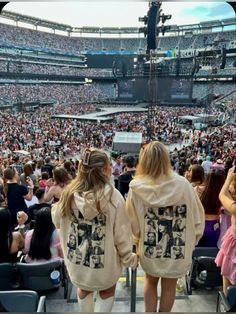 two girls standing in front of an audience at a concert