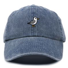 Embrace coastal charm with our Seagull Dad Cap, adding a touch of whimsy and seaside allure to your ensemble. Discover the perfect blend of style and comfort with our classic dad cap, tailored to fit effortlessly into your everyday wardrobe. This timeless hat features a convenient adjustable slider at the back, ensuring a customizable fit for all head sizes. Designed with functionality in mind, the cap includes eyelet holes for enhanced breathability, keeping you cool and comfortable throughout Cotton Brimmed Dad Hat For Beach, Embroidered Baseball Cap For Beach, Blue Baseball Cap For Beach, Casual Embroidered Hats For The Beach, Casual Embroidered Beach Hats, Casual Blue Embroidered Hats, Embroidered Baseball Cap For Beach With Curved Brim, Embroidered Baseball Cap With Curved Brim For Beach, Embroidered Baseball Cap For Beach, One Size Fits Most