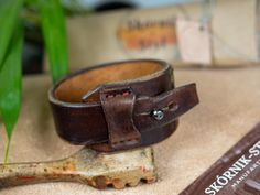 Genuine leather bracelet decorated with Baltic amber for a unique woman. This unique bracelet was made entirely by hand from a single piece of thick cowhide. dimensions: - thickness 4-5 mm - width at the widest point 3.8 cm - max inner circumference of the fastened bracelet 18.5 cm - fits wrist up to 17 cm in circumference This unique bracelet will be the best gift for your beloved woman. Adjustable Leather Bracelet With Strap, Adjustable Leather Wristband With Waxed Finish, Vintage Brown Leather Bracelet As A Gift, Vintage Brown Leather Bracelet As Gift, Vintage Brown Leather Strap Bracelet As Gift, Adjustable Vintage Brown Leather Jewelry, Adjustable Vintage Brown Bracelets As Gift, Adjustable Brown Leather Bracelet Gift, Adjustable Vintage Brown Bracelet For Gift