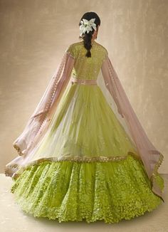 Elegance meets vibrant charm in this exquisite Lime Green Embroidered Net Lehenga Set, designed to make a captivating statement. Crafted from soft net fabric, the flowy lime green lehenga features delicate gathers at the waist, adorned with scattered floral embroidery crafted from shimmering sequins and intricate threadwork, adding a touch of opulence to every twirl. Paired with a matching blouse, the design flaunts a sweetheart neckline and a sheer back that strikes the perfect balance between Green Cutdana Gown For Reception, Green Cutdana Sharara For Wedding, Green Semi-stitched Gown With Cutdana, Pista Green Traditional Drape Gown For Reception, Pista Green Anarkali Gown With Cutdana, Green Organza Lehenga For Wedding, Pista Green Organza Choli With Cutdana, Green Organza Wedding Gown, Pista Green Gown With Resham Embroidery For Wedding