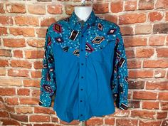 "Painted Mesa vintage western shirt. Excellent lightly used condition no major issues MEASURES - 21\" pit to pit and 27\" long TAGGED - M ~ BE SURE TO CHECK OUT MY ENTIRE SHOP ~ - This is a TRUE VINTAGE item! Vintage clothing sizing varies wildly ALWAYS use the measurements and info provided in the listing to assure proper fit! Unless the words \"deadstock\" or \"unworn\" are used please understand this is a USED item. RETURNS - My policy is NO RETURNS but I will make an exception if you agree t Fitted Bohemian Shirt For Festivals, Western Style Graphic Print Shirt For Fall, Western Style Long Sleeve Tops For Festival, Western Style Graphic Print Fall Shirt, Western Style Long Sleeve Shirt With Graphic Print, Blue Vintage Western Style Tops, Fitted Western Shirt For Western-themed Events, Grunge Cowboy, Western Style Long Sleeve Graphic Print Shirt