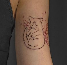 a small cat tattoo on the arm