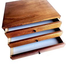 three wooden drawers stacked on top of each other