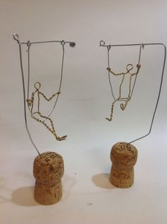 two wine corks with chains attached to them