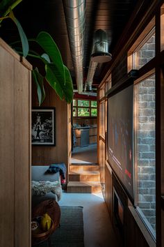 a living room filled with furniture and a flat screen tv mounted to the side of a wall