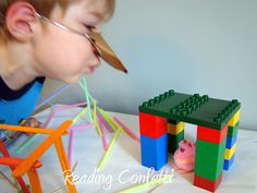 a young boy playing with toys made out of legos