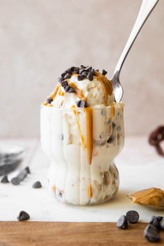 an ice cream sundae with chocolate chips and caramel drizzle