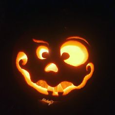 a carved pumpkin with an evil face on it's face, lit up in the dark