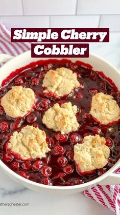 a white bowl filled with cranberry cobbler on top of a table