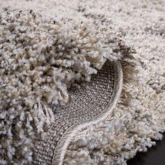 a pile of white and brown carpet on top of a wooden floor