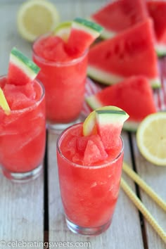 three glasses filled with watermelon margaritas on top of a cutting board