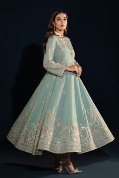 Aqua Blue Embellished Frock Pakistani Party Dress embraces tradition in this aqua-hued kalidar frock jeweled with hand adda embellishments on the bodice. Embellished Green Dress For Navratri, Embroidered Embellished Dress For Wedding And Diwali, Embroidered Dress For Wedding Diwali, Green Embellished Anarkali Set, Blue Embellished Georgette Anarkali Set, Embellished Green Anarkali Set, Anarkali Embroidered Dress With Mirror Work For Weddings, Blue Maxi Lehenga With Mirror Work, Blue Embroidered Party Dress