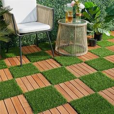 a chair and table sitting on top of a grass covered ground