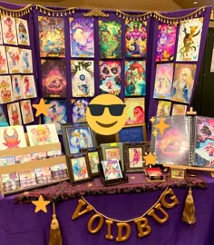 a purple table topped with pictures and decorations