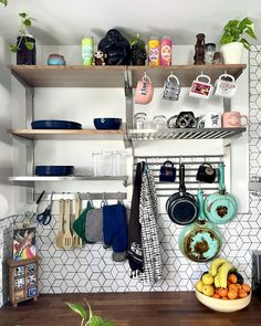 a kitchen with shelves filled with pots, pans and other cooking utensils